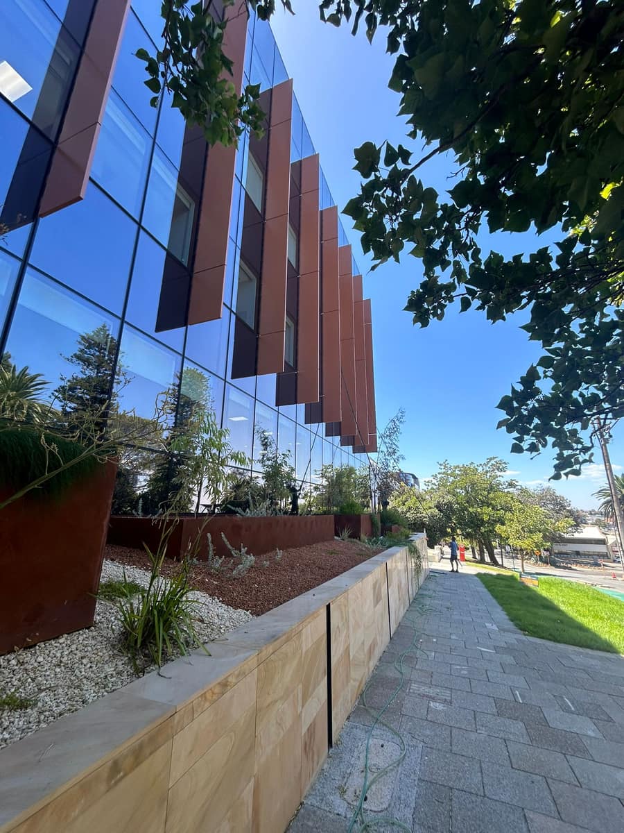 Commercial building entrance with garden and paved pathway, Perth