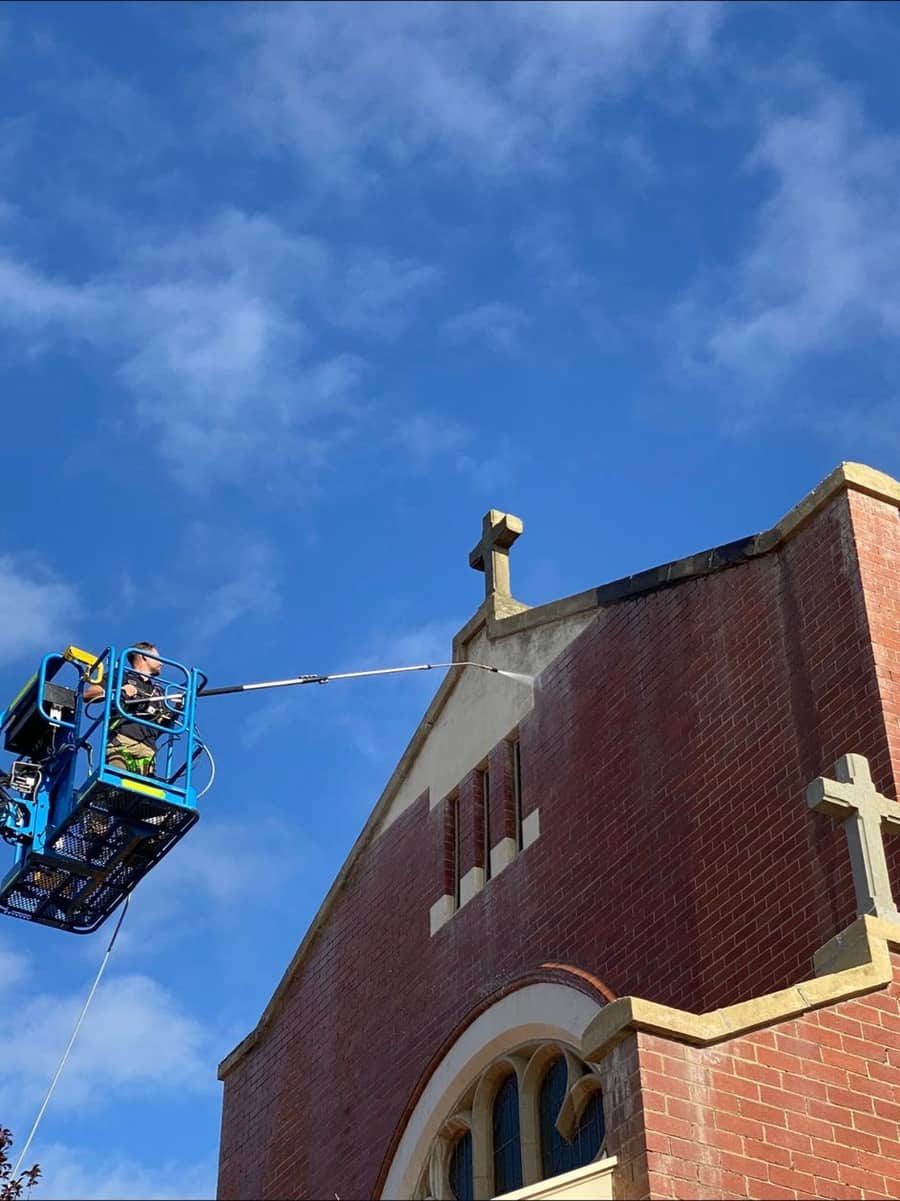 Gutter and eaves cleaning on a brick church using an elevated access platform, Purified Group Perth