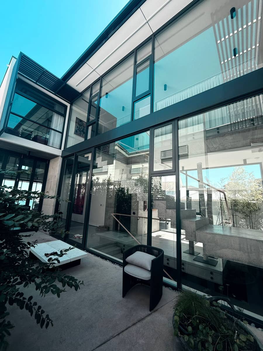 Freshly cleaned glass walls on a modern Perth home, streak-free finish, Purified Group