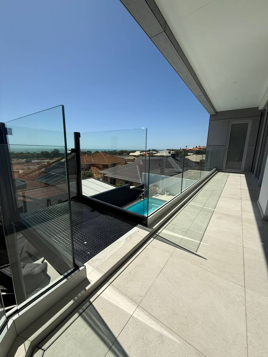 Glass pool fence on a Perth home with suburb and coastline views after cleaning