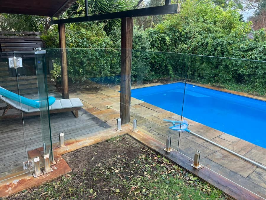 After: clean glass pool fence, pool and garden visible, Perth