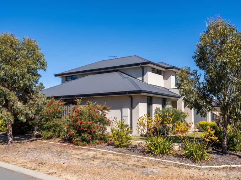 Wide exterior shot of a two-storey Perth home roofline and gutters