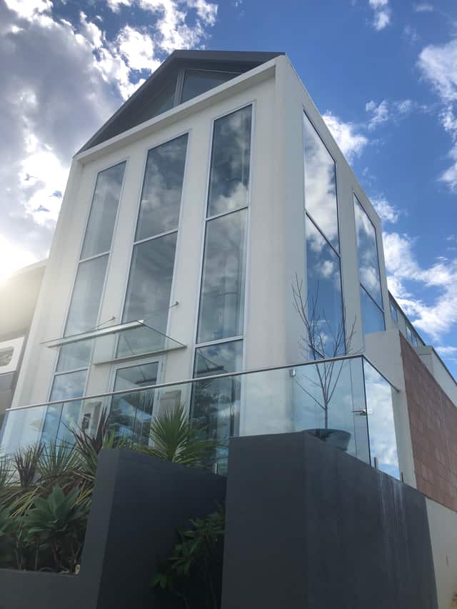 Modern Perth building with floor-to-ceiling glazing and glass balustrade