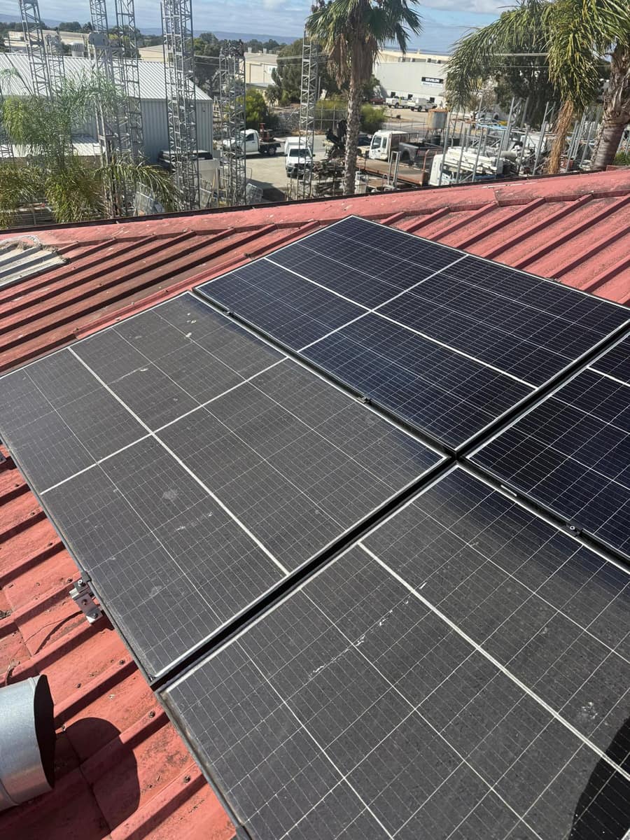 Solar panels on a red roof showing a before and after split, Perth
