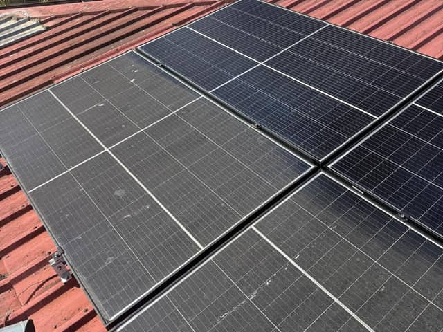 Dull, dust-covered solar panels beside freshly cleaned glossy panels on a red Colorbond roof in Perth
