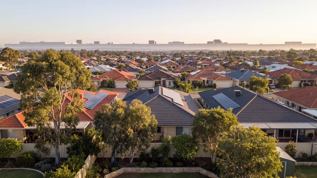 A leafy Perth suburban street with mature trees, a home with solar panels visible, Booragoon