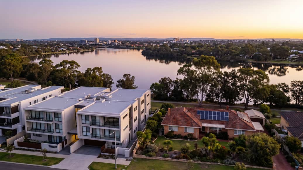 A Perth riverside suburb under jacaranda and gum trees, a home with solar panels visible, Como