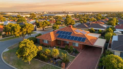An established Perth home with solar panels, an industrial precinct visible on the horizon, Hamilton Hill