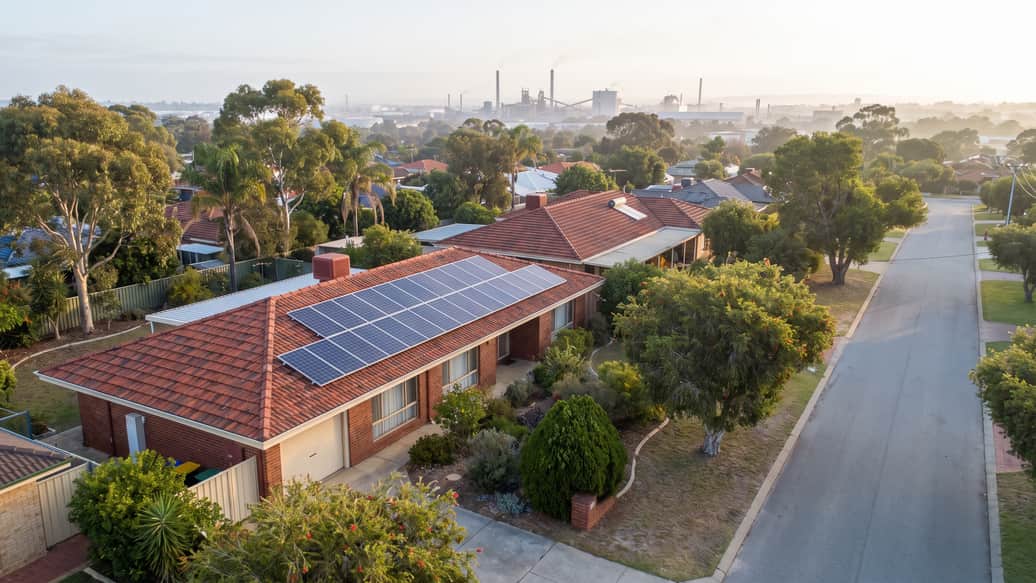 An established Perth home with solar panels, an industrial precinct visible on the horizon, Hope Valley