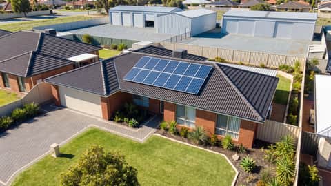 An established Perth home with solar panels, an industrial precinct visible on the horizon, Parmelia