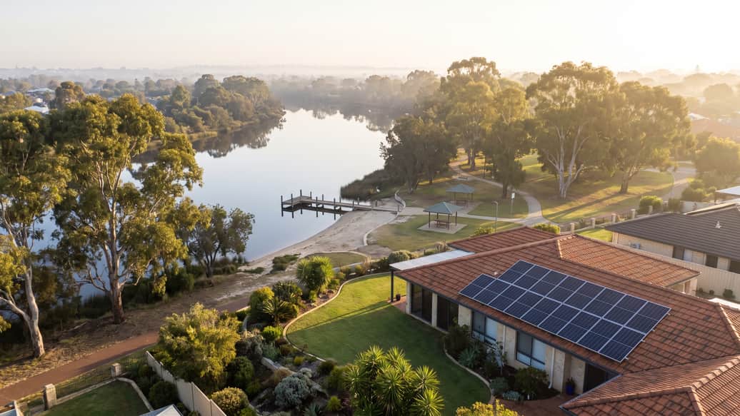 A Perth riverside suburb under jacaranda and gum trees, a home with solar panels visible, Melville