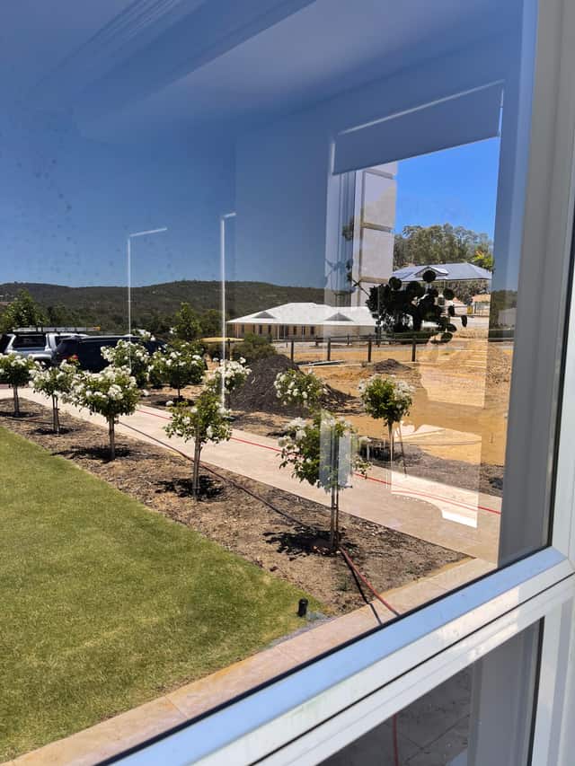 View out through a clean window over a landscaped Perth garden